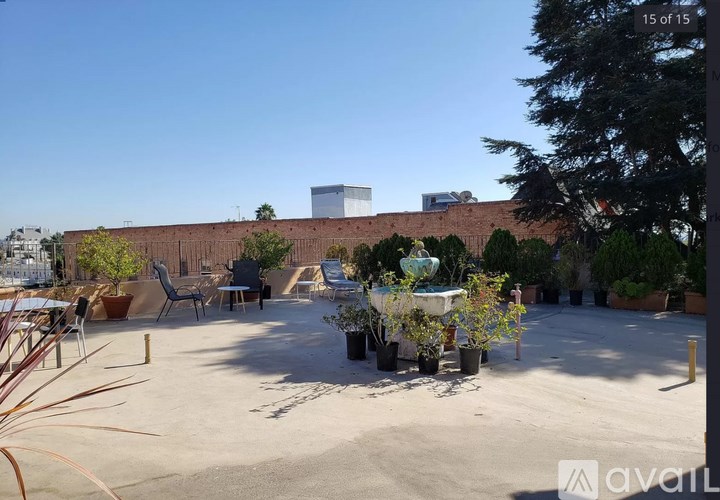 A courtyard with a fountain and chairs.