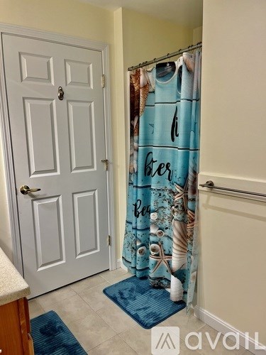 A white door with a blue mat in front of it.