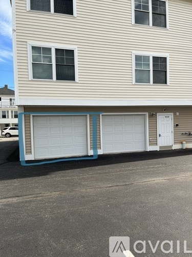 A two-story house with a garage door painted blue.