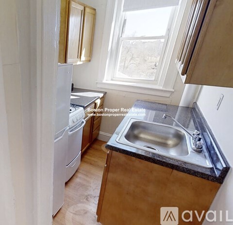 A kitchen with a sink and a window.
