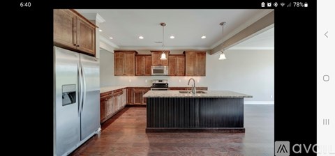 A modern kitchen with wooden cabinets and a central island.