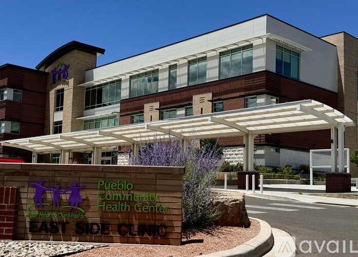 A modern building with a sign that reads "Pueblo Community Health Center East Side Clinic".