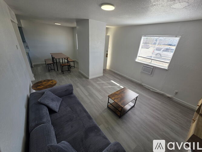 A living room with a grey couch and a wooden coffee table.