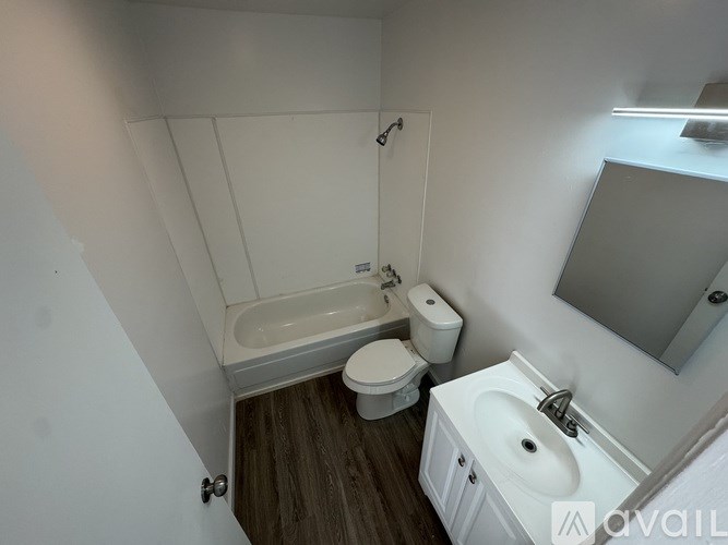 A small bathroom with a toilet, sink, and bathtub.