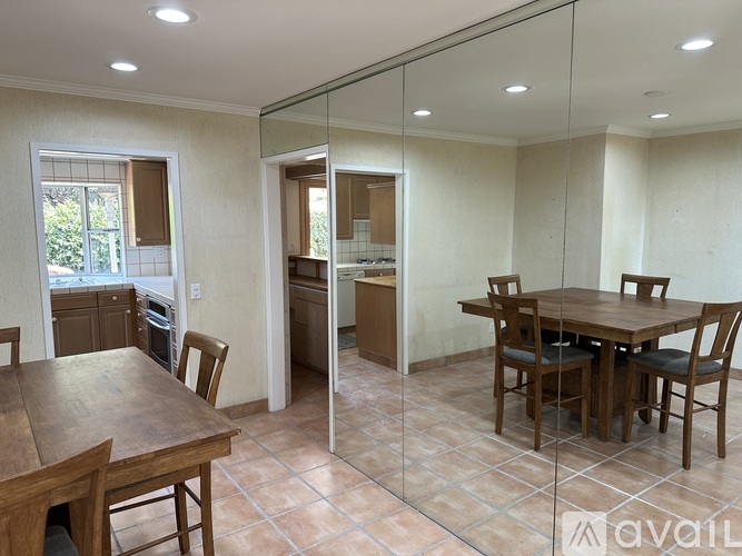 A dining room with a wooden table and chairs is shown.