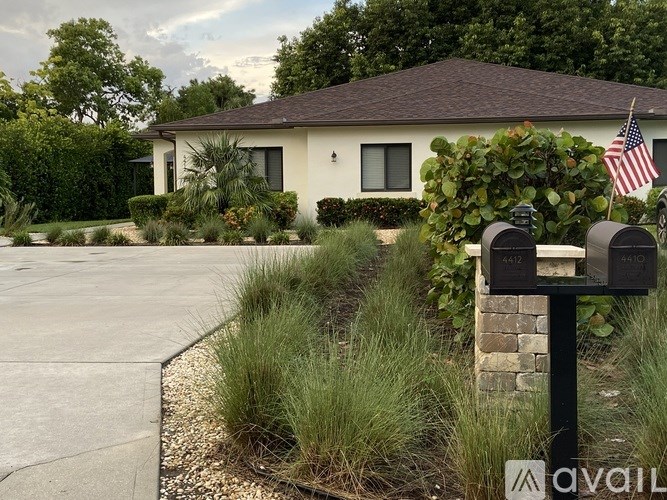 A house with a driveway and a mailbox in front of it.