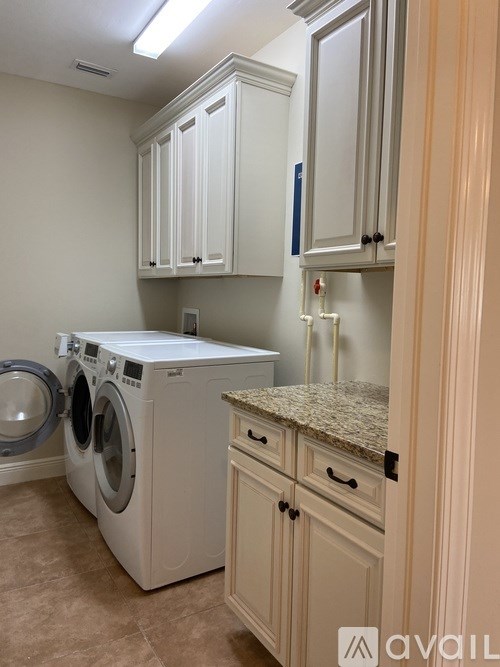 A laundry room with a washer and dryer.