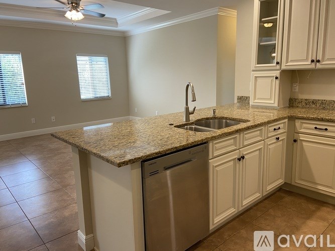 A kitchen with a granite countertop and stainless steel appliances.