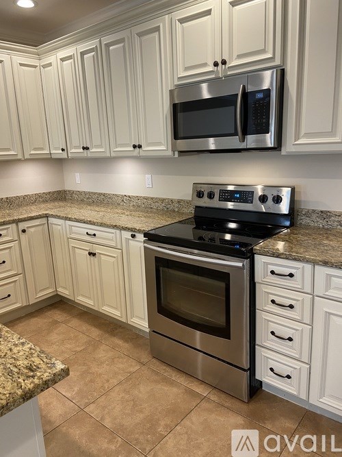 A kitchen with granite countertops and stainless steel appliances.