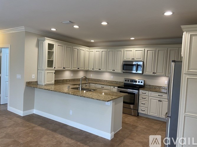 A kitchen with granite countertops and stainless steel appliances.