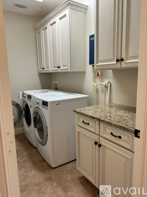 A laundry room with a washer and dryer.