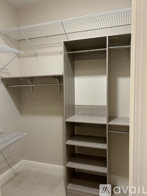 A walk-in closet with shelves and hanging rails.