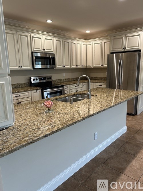 A kitchen with granite countertops and stainless steel appliances.