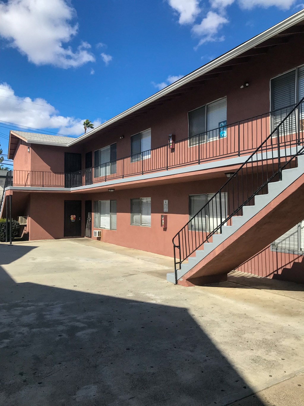 the outside of a building with stairs and a parking lot