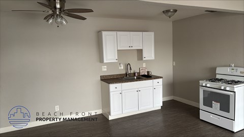 A kitchen with a stove and cabinets is shown in this image.