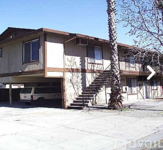 A two-story house with a van parked in the garage.