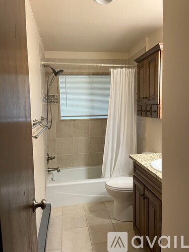 A bathroom with a toilet, sink, and bathtub.