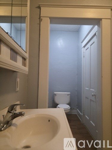 A bathroom with a toilet and a sink.