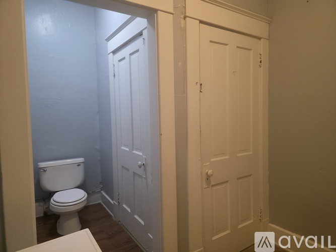 A bathroom with a toilet and a door.
