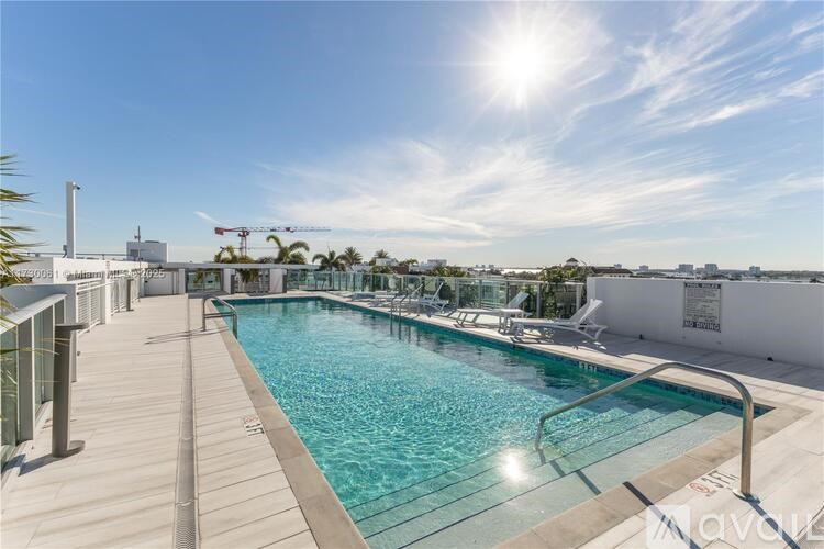 A sunny day at the rooftop pool with a clear blue sky.