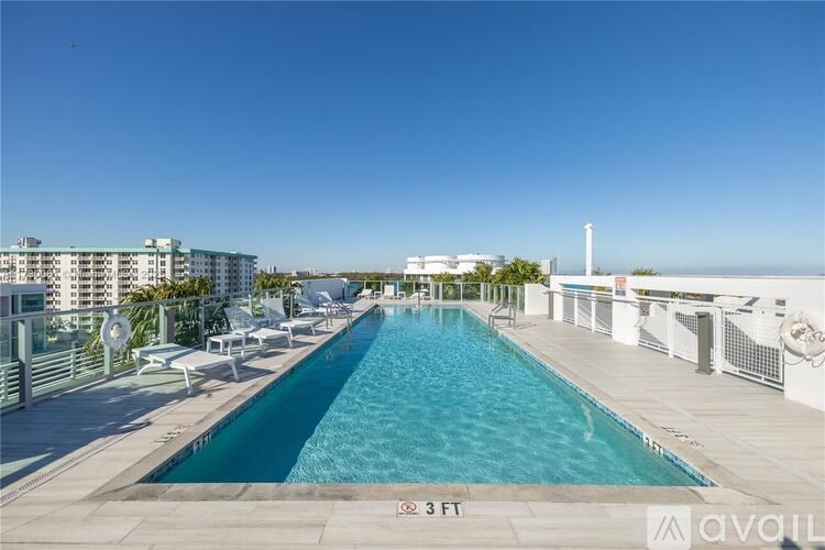A large outdoor pool with a view of the city.