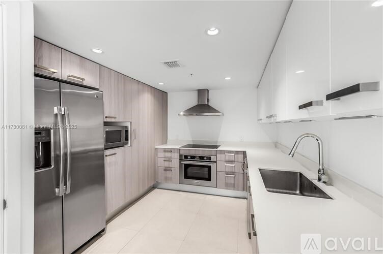 A modern kitchen with stainless steel appliances and a center island.