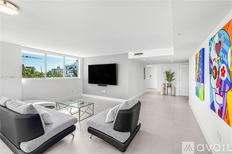 A living room with two black couches and a television.