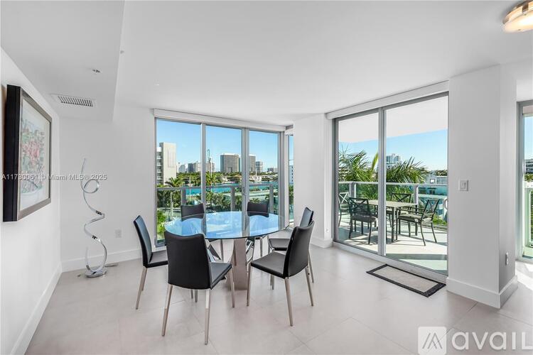 A dining room with a table and chairs and a view of the city.