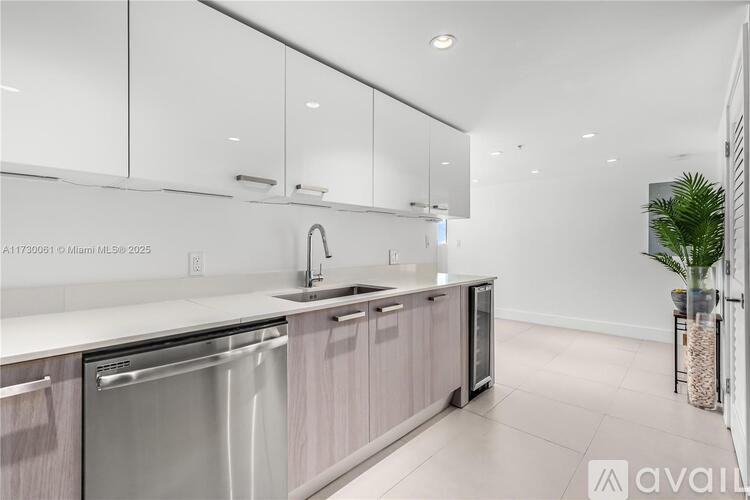 A modern kitchen with a stainless steel dishwasher and a sink.