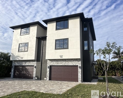 A modern two-story house with a garage is for sale.