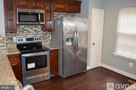 A kitchen with a stove, oven, and refrigerator.