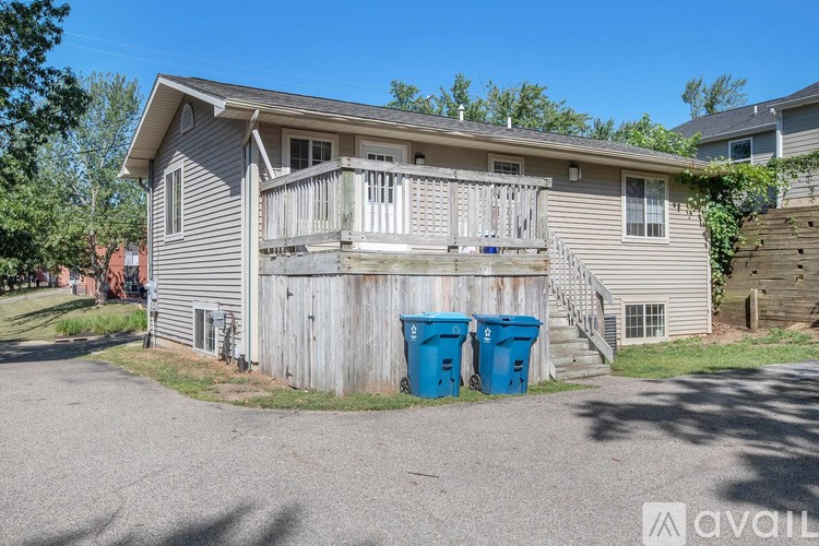 A house with a grey siding and a wooden fence.