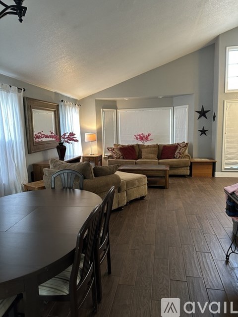 A living room with a brown table and chairs.