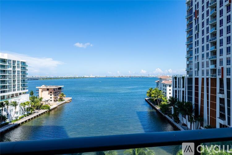 A view from a balcony overlooking a body of water with buildings on either side.