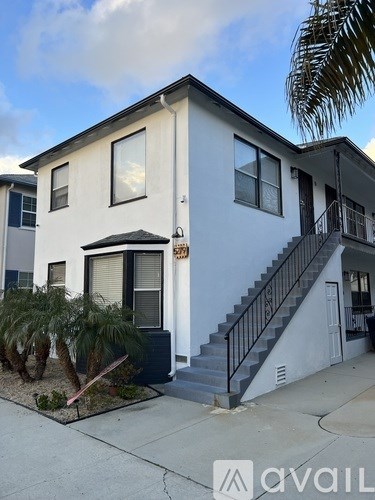 A two-story house with a staircase leading to the second floor.