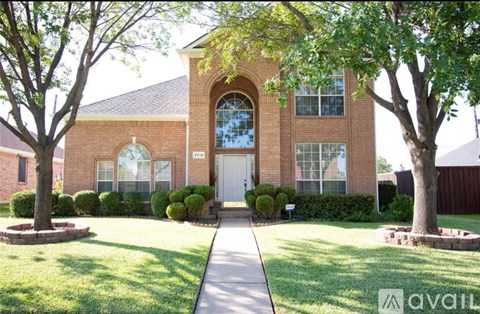 A house with a front yard and a driveway.