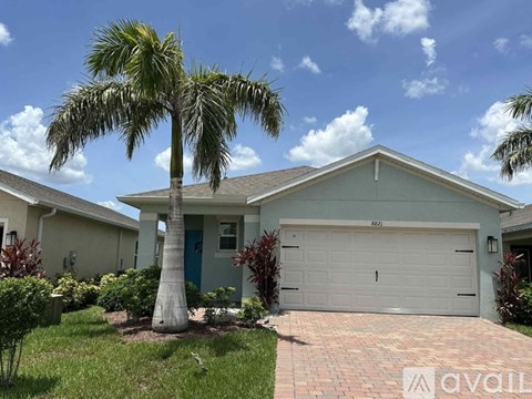 A house with a palm tree in front of it.
