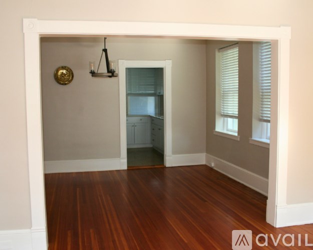 A room with wooden floors and a white door.