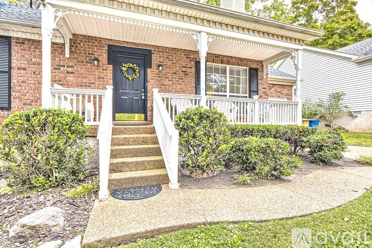 A house with a black door and a wreath on it.