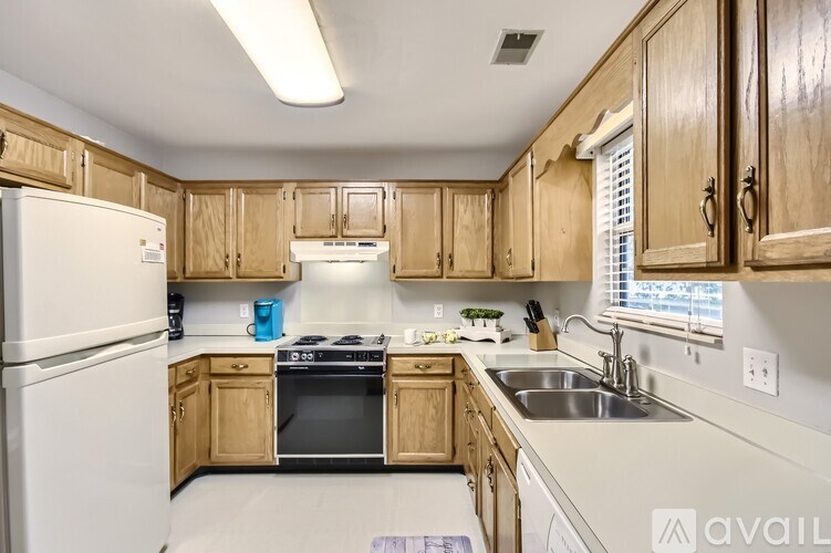 A kitchen with wooden cabinets and a white refrigerator.