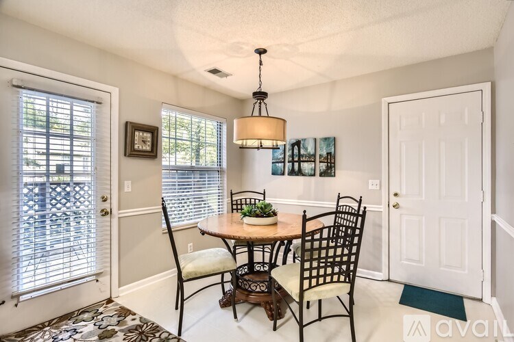 A dining room with a table set for two.