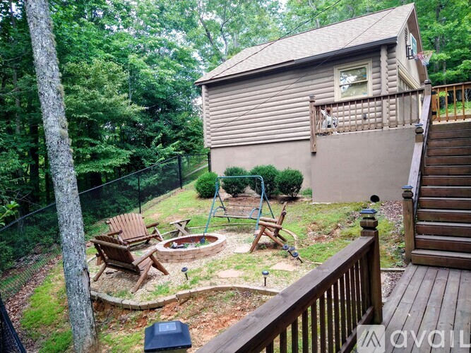 A backyard with a hot tub and deck.