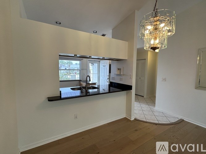 A bathroom with a white toilet, sink, and a mirror with lights above it.
