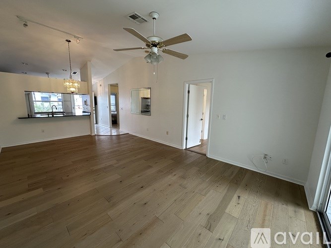A white refrigerator in a kitchen with wooden cabinets.