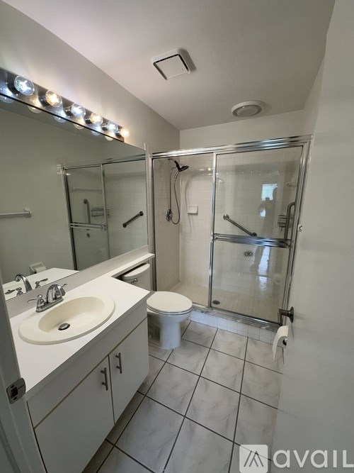 A balcony with a chair and a table with a potted plant on it.