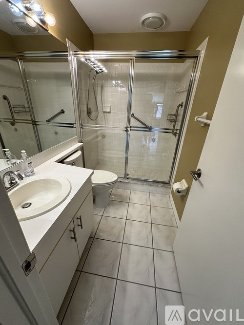A bathroom with a sink, toilet, and shower.