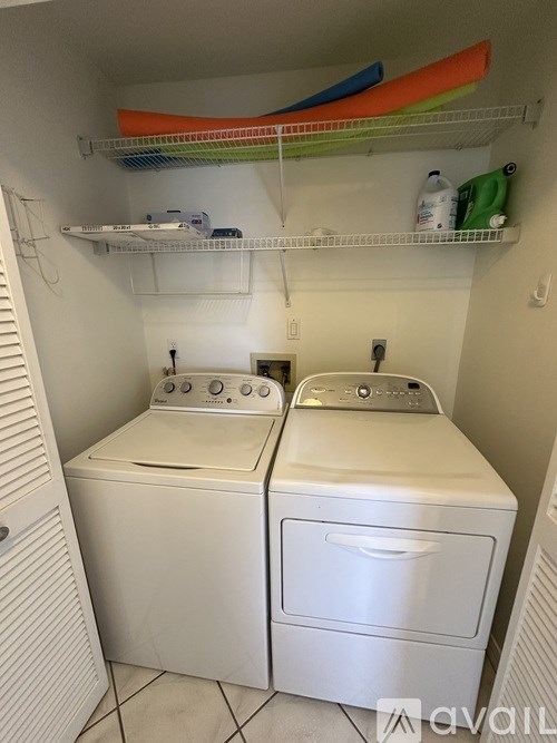 A small laundry room with a washer and dryer.