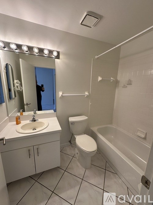 A bathroom with a sink, toilet, and bathtub.