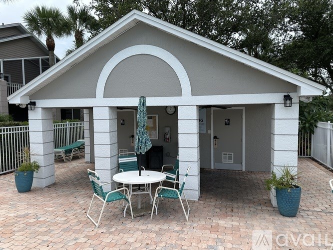 A kitchen with a black countertop and a brown stool.