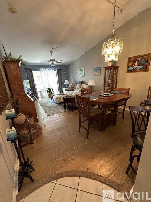 A living room with a wooden table and chairs.